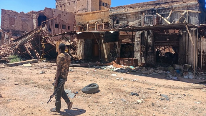 A fighter loyal to the army patrols a market in Khartoum. The only force capable of preserving Sudan’s unity is a democratic, civilian-led government © AFP/Getty Images